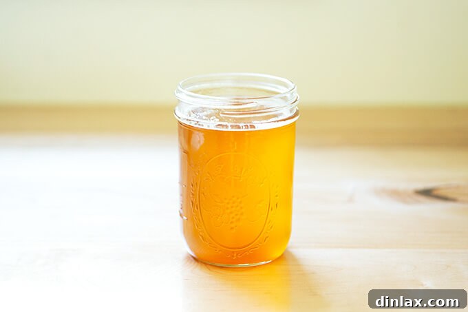 The Art of Ghee Making: A Home Kitchen Guide 9 A jar of homemade ghee, now cooled and solidified to a beautiful golden texture, showcasing its freshness.