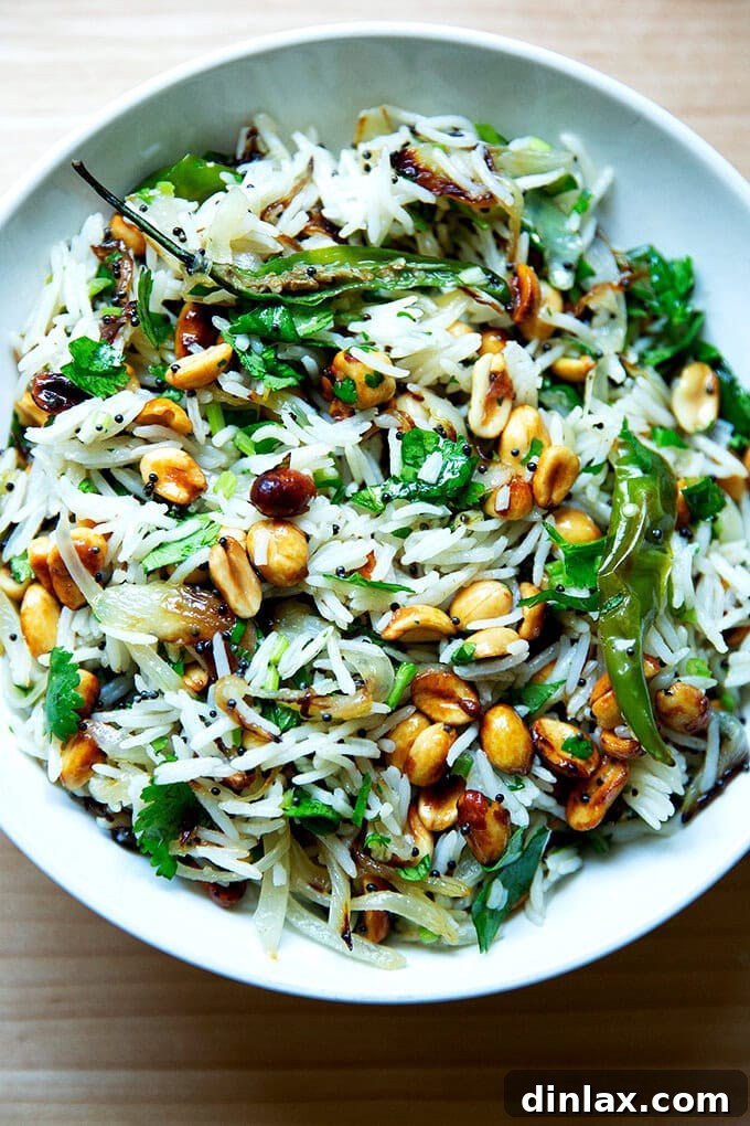 A vibrant bowl of Indian Fried Rice, garnished with peanuts, fresh chilies, and bright cilantro, promising an explosion of flavors.