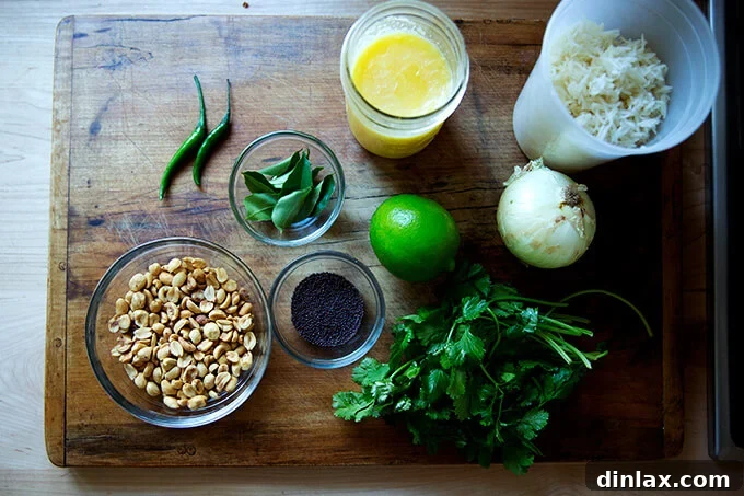 All the fresh and vibrant ingredients neatly laid out for Indian fried rice, including basmati rice, peanuts, chilies, cilantro, lime, and various spices.