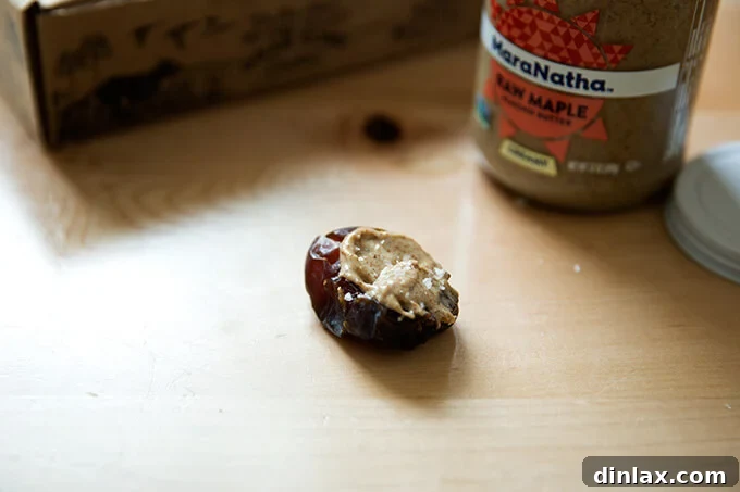 A beautifully presented date spread, artfully topped with almond butter and sea salt flakes.
