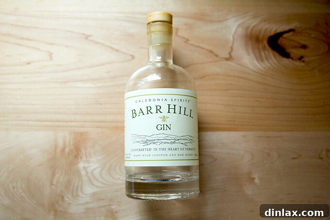 A pristine bottle of Barr Hill Gin, showcasing its elegant label and amber hue.