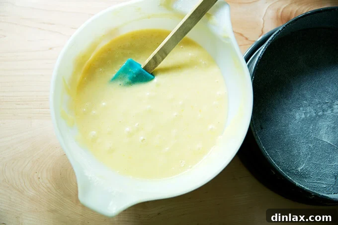 Creamy Rhubarb Dream Cake 4 A vibrant, pale yellow batter for the rhubarb-custard cake, showcasing its smooth and thick texture.