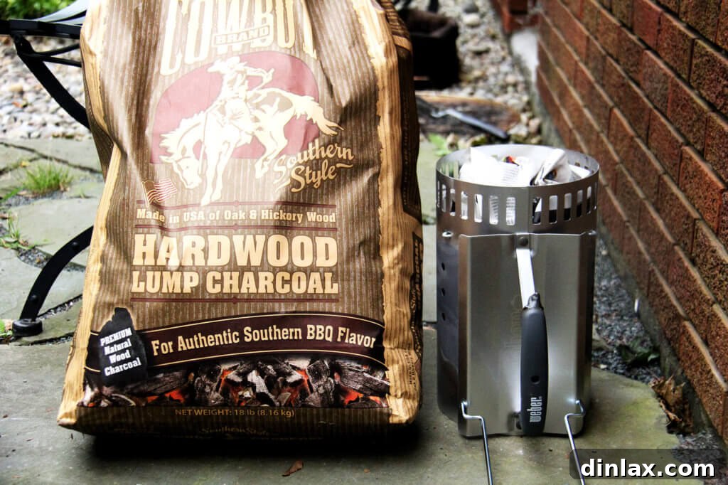 Close up view of burning lump charcoal in a chimney starter.