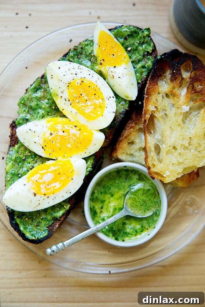 The Ultimate Herby Avocado Green Sauce 2 A plate of toasted sourdough smeared with green sauce, topped with 7-minute eggs, promising a delightful culinary experience.