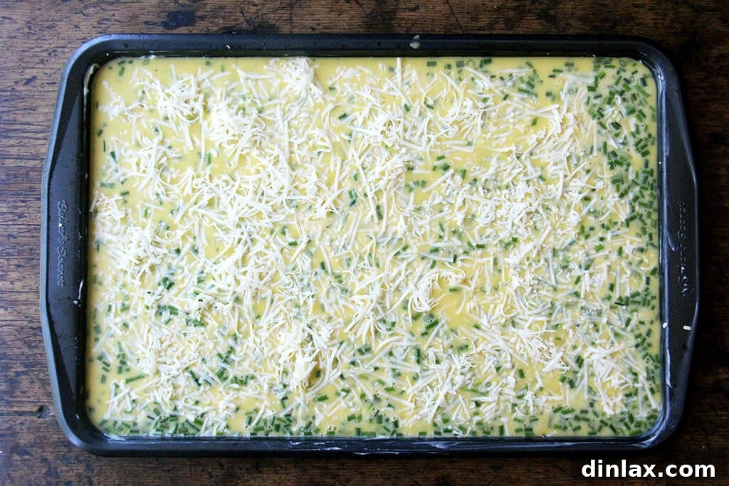 Ultimate Sheet Pan Breakfast Slab Sandwich: Bacon, Egg, and Cheese 4 Eggs on a sheet pan ready for the oven.