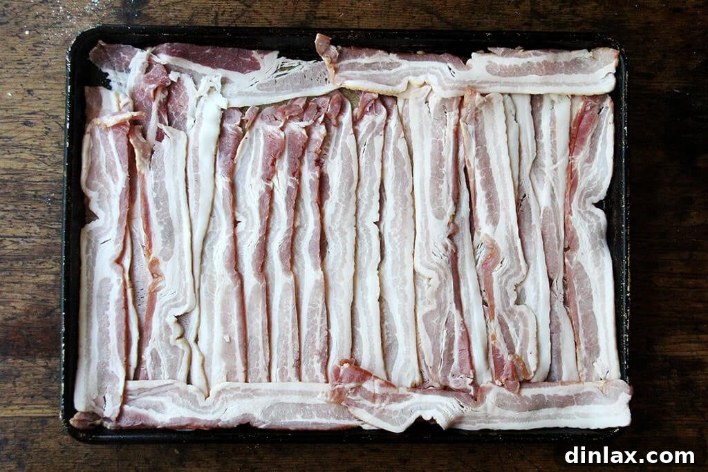 Ultimate Sheet Pan Breakfast Slab Sandwich: Bacon, Egg, and Cheese 7 sheet pan loaded with uncooked bacon