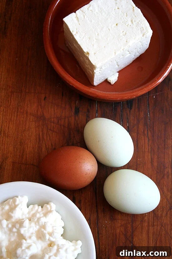 Key Tiropitas ingredients: fresh eggs, small curd cottage cheese, and crumbled feta cheese.