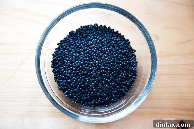 Irresistible Black Lentil and Spinach Delight 3 A close-up of cooked black lentils in a bowl, showcasing their distinct shape.