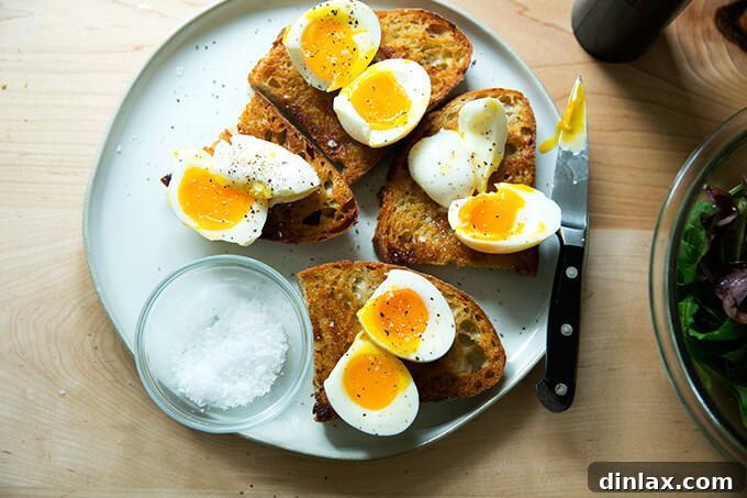 Jammy Eggs & Tangy Olive Oil Toast 10 A plate of cut eggs on vinaigrette toast, seasoned.