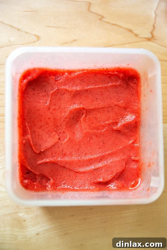 Refreshing Strawberry Sorbet Nestled in Buttery Almond Butterscotch Cookie Cups 11 A tub of creamy strawberry sorbet, softened to the perfect scooping consistency.