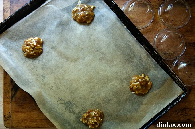 Refreshing Strawberry Sorbet Nestled in Buttery Almond Butterscotch Cookie Cups 13 Almond butterscotch cookie batter drops on a parchment-lined baking sheet, spaced for baking.
