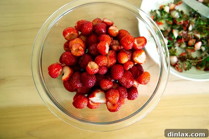 Refreshing Strawberry Sorbet Nestled in Buttery Almond Butterscotch Cookie Cups 4 Close-up of clean, hulled strawberries, showcasing their vibrant red color.