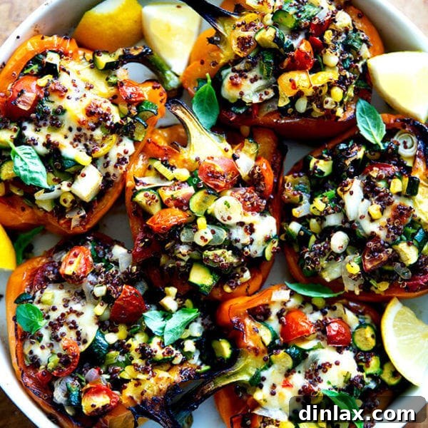 Roasted bell peppers stuffed with quinoa and sautéed corn, zucchini, and tomatoes.