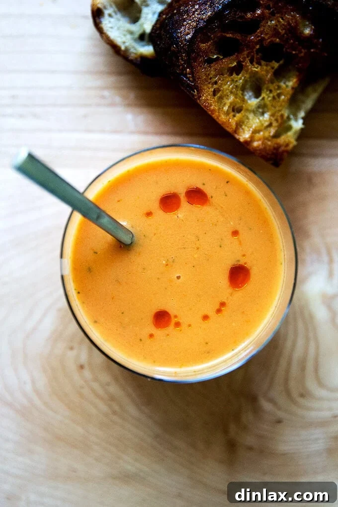 Cultivating Conversations: Margaret Roach on Tomatoes, Corn, and Zucchini 2 A vibrant bowl of Julia Moskin's Best Spanish Gazpacho, garnished with fresh herbs.