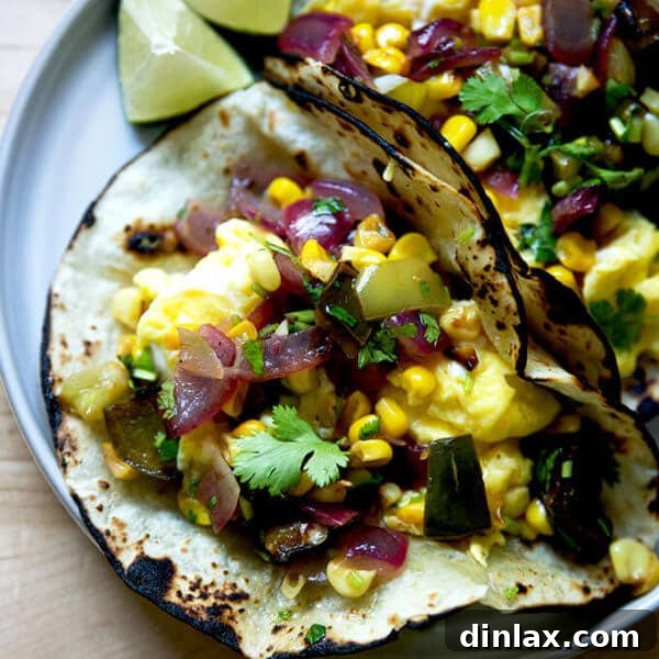 A plate of an egg taco topped with roasted vegetable salsa.