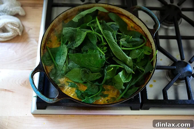 A sauté pan with a heap of spinach.