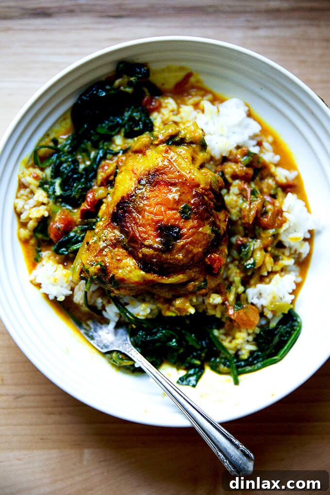 A bowl of one-pot Thai chicken curry with spinach and rice