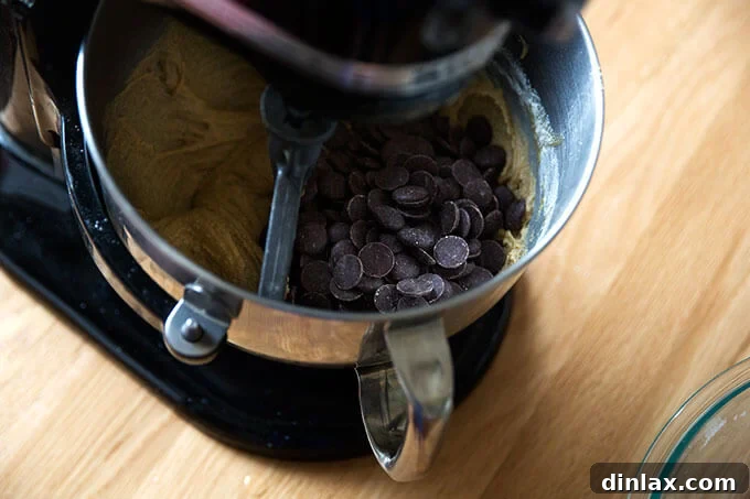 Decadent Gluten-Free Chocolate Chip Cookies 15 A stand mixer incorporating chocolate chip wafers into the gluten-free cookie batter, ensuring even distribution.