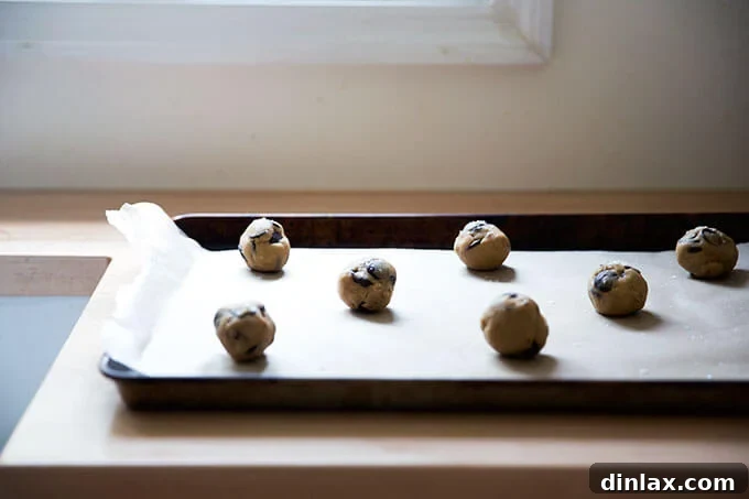Decadent Gluten-Free Chocolate Chip Cookies 17 Gluten-free cookie dough balls, perfectly shaped and arranged on a sheet pan, ready to be baked from frozen.