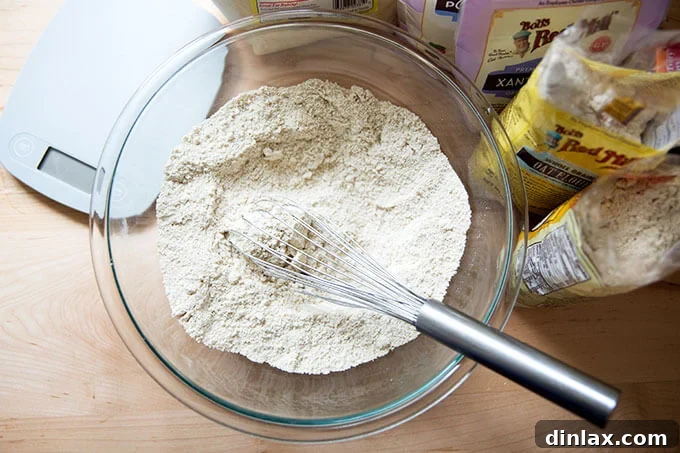 Decadent Gluten-Free Chocolate Chip Cookies 3 Dry ingredients for gluten-free chocolate chip cookies perfectly whisked together in a bowl, showcasing the importance of precise measurements.