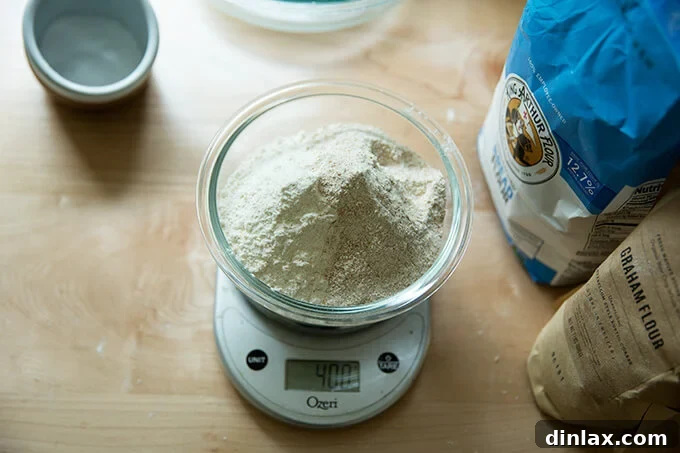 Simple Sourdough with a Hearty Whole Grain Touch 7 A mixing bowl on a digital scale, filled with a precise blend of bread flour, graham flour, and rye flour.
