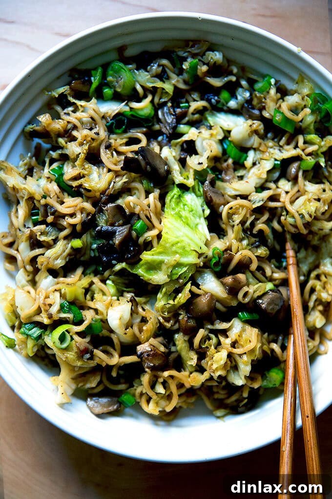 A beautifully plated bowl of one-pot ginger-scallion ramen noodles, garnished with fresh scallions and sesame seeds, ready to be enjoyed.