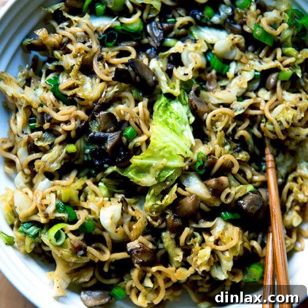 A bowl of one-pot ginger-scallion ramen noodles, garnished with fresh scallions and sesame seeds.
