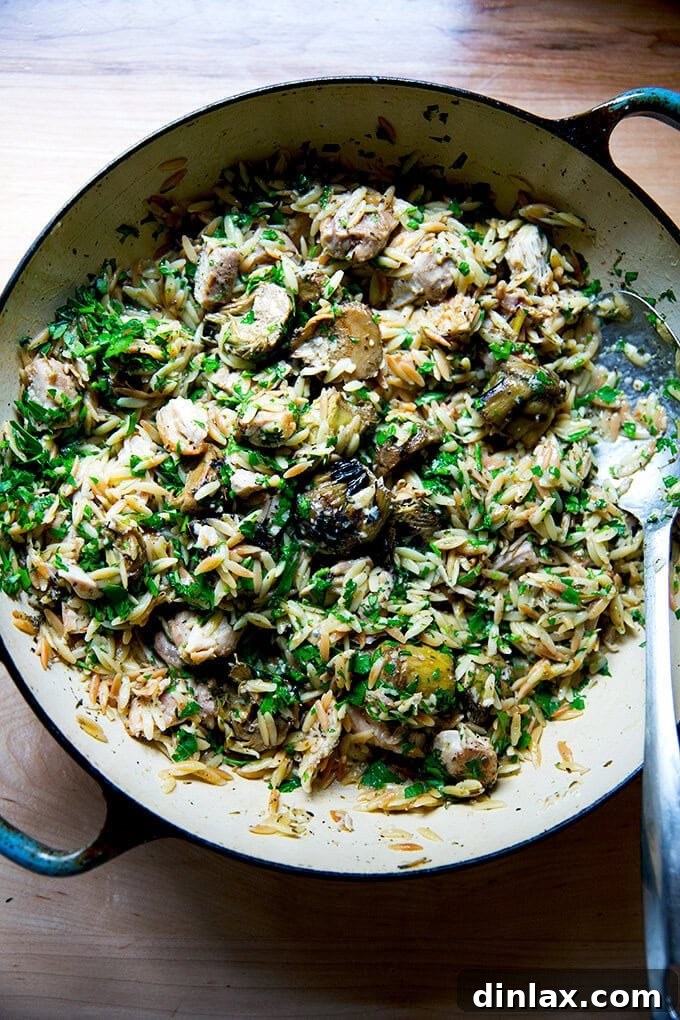 Zesty Lemon Artichoke Orzo Chicken Skillet 15 An overhead view of the finished one-pan lemon chicken orzo with artichoke hearts, ready to serve from the skillet.