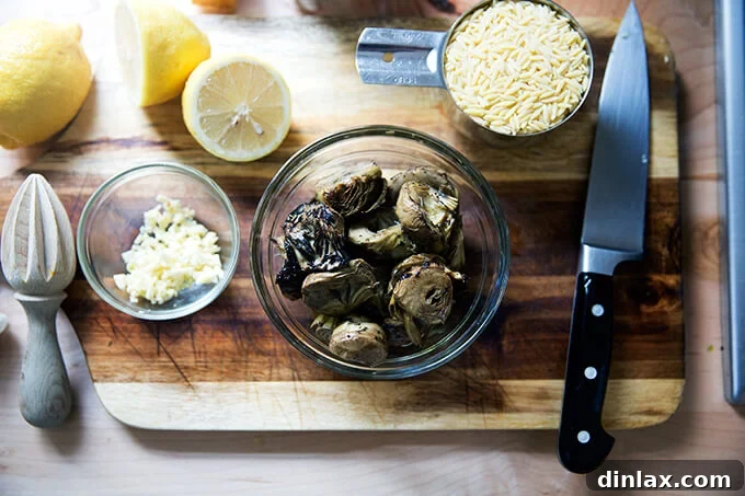 Zesty Lemon Artichoke Orzo Chicken Skillet 5 A bowl filled with succulent Trader Joe's grilled artichoke hearts on a rustic wooden board.