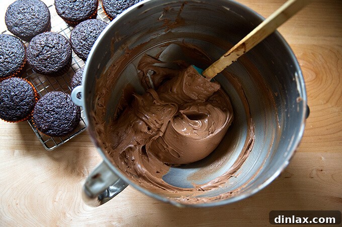 A bowl of rich, smooth chocolate buttercream frosting, ready for decorating.