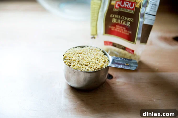 A cup of extra-coarse bulgur (Turkish, Duru brand) in a transparent measuring cup, ready for preparation.