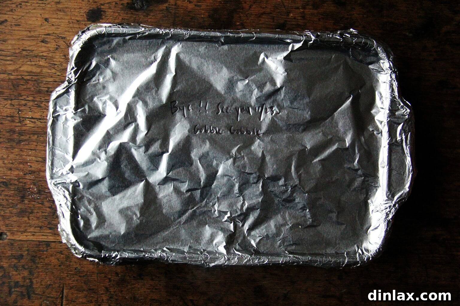 A 9x13-inch baking pan, securely covered with aluminum foil, indicating it's ready for either immediate baking or freezing.