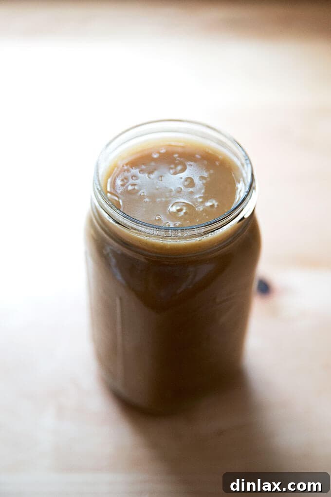 A large Mason jar filled with make-ahead gravy.