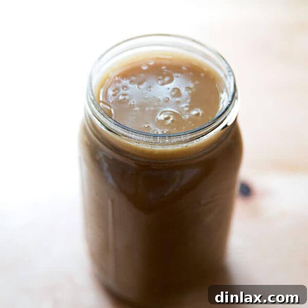 A large Mason jar filled with make-ahead gravy.