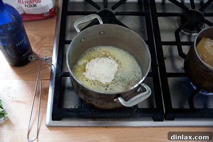 A saucepan filled with melted butter and flour.