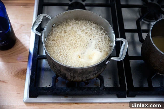 A saucepan filled with gravy simmering.