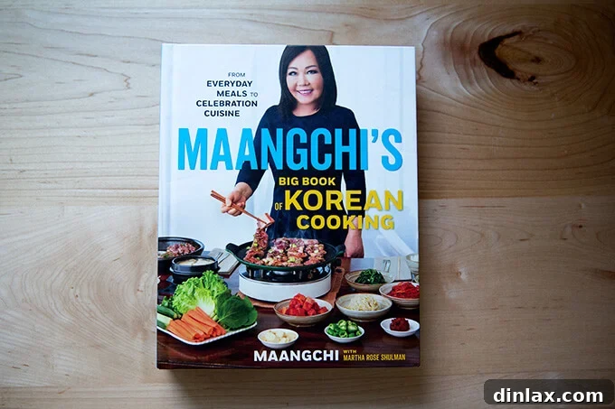 Japchae: Vegetarian Korean Glass Noodles 18 A beautifully designed cookbook, Maangchi's Big Book of Korean Cooking, resting on a kitchen counter, inviting readers to explore Korean culinary traditions.
