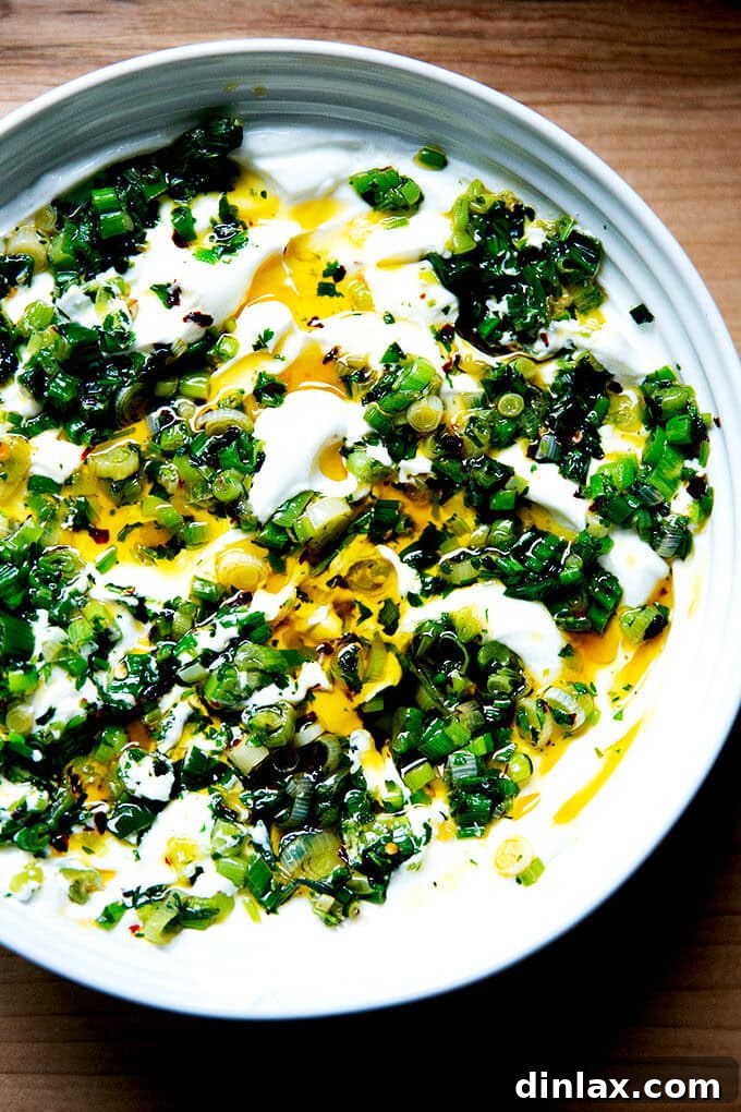 Wholesome Greek Yogurt Ranch Dip 2 Homemade ranch dip in a bowl, topped with sizzling chili oil and fresh herbs.