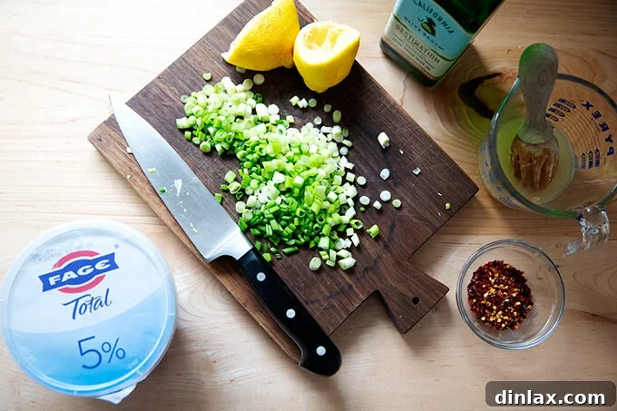 Wholesome Greek Yogurt Ranch Dip 3 Freshly chopped scallions on a wooden cutting board.