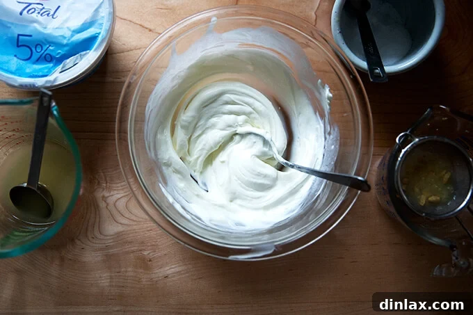 Wholesome Greek Yogurt Ranch Dip 7 Creamy Greek yogurt mixed with lemon and salt in a bowl.