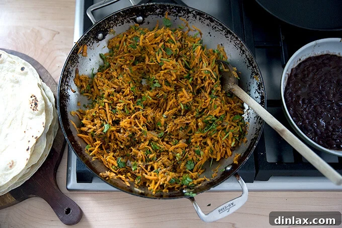 Overhead shot of a skillet holding sweet potato taco filling.