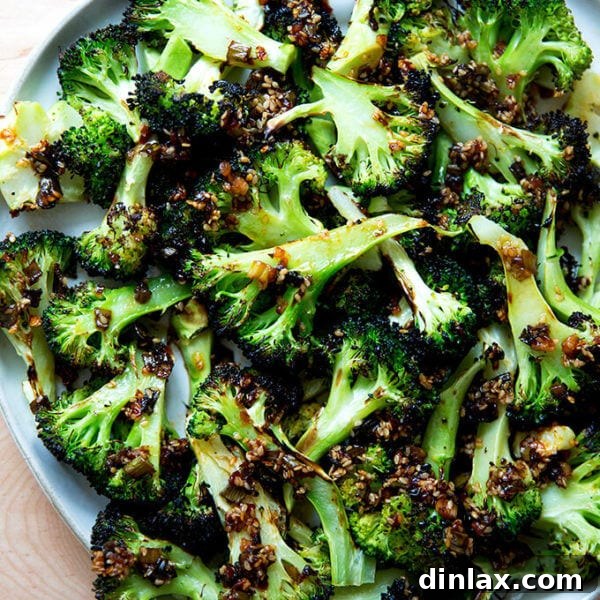 Spicy broiled broccoli with sesame-scallion oil on a plate.