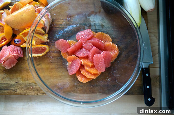 Beautifully segmented citrus in a bowl, glistening with natural juices.