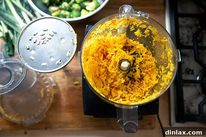 Freshly shredded golden beets, adding color and earthy sweetness to the salad.