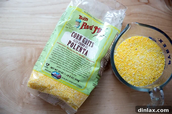 A small bag of polenta next to a measuring cup filled with golden polenta grains.