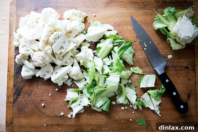 A head of cauliflower expertly cut into uniform florets, ready for the curry pot.