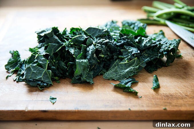 Fresh kale, finely chopped and piled on a cutting board, ready for the curry.