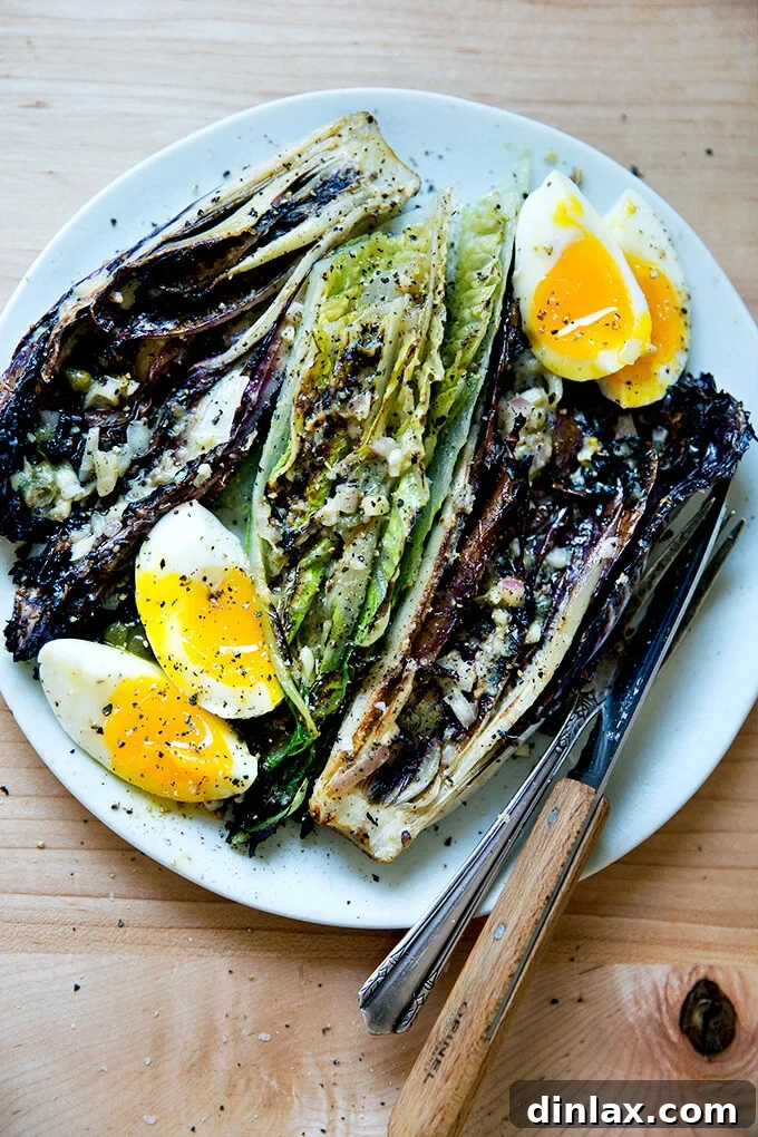 Fire-Kissed Romaine Caesar 14 A plate of grilled Romaine salad with soft-boiled eggs.
