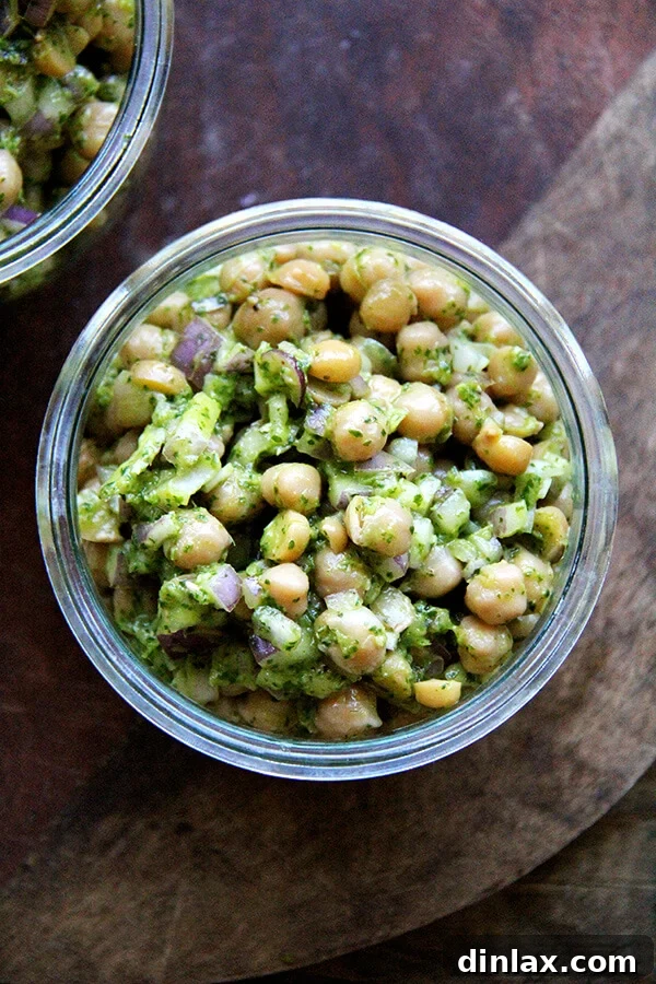 10 Essential Chickpea Recipes You Need Today 5 A vibrant bowl of cilantro-lime chickpeas, garnished with fresh cilantro leaves and lime wedges, ready to be enjoyed.