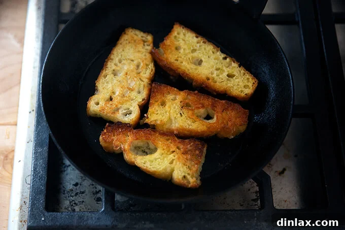 Crispy, golden-brown focaccia slices, perfectly toasted in olive oil and ready to accompany the soup.